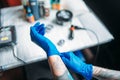 Female tattoo artist hands in blue sterile gloves