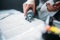 Female tattooist hands holds tattoo machine