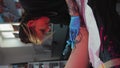 Female tattooist wearing gloves making tattoo on her client leg in tattoo studio