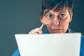 Female tax inspector looking at document with magnifying glass Royalty Free Stock Photo