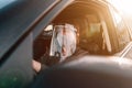 Female taxi driver with protective face mask and plastic visor Royalty Free Stock Photo