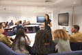 Female teacher addressing university students in a classroom Royalty Free Stock Photo