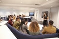 Female teacher addressing university students in a classroom Royalty Free Stock Photo