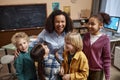 Female teacher with diverse group of little children Royalty Free Stock Photo