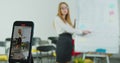 Female teacher having online class. Smiling woman talking to students via video conference on smartphone. Remote Royalty Free Stock Photo