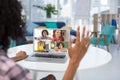 Female teacher having a video conference with multiple students on laptop at home Royalty Free Stock Photo