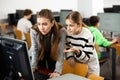 Female teacher helping teen schoolgirl studying in computer lab Royalty Free Stock Photo