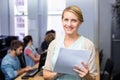 Female teacher holding document in computer class Royalty Free Stock Photo