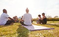 Female Teacher Leading Group Of Mature Men And Women In Class At Outdoor Yoga Retreat Royalty Free Stock Photo