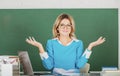 Female teacher. Pretty young high school or college teacher on the chalkboard. Young caucasian female teacher portrait