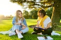 Female teacher psychologist social worker talking to teenage student on the lawn Royalty Free Stock Photo