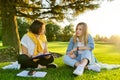 Female teacher psychologist social worker talking to teenage student on the lawn Royalty Free Stock Photo