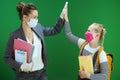 Female teacher and pupil high five isolated on chalkboard green