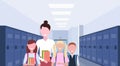Female teacher with schoolchildren group standing in school corridor interior with rows of blue lockers education Royalty Free Stock Photo