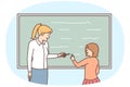 Female teacher and schoolgirl writing on blackboard