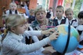 Female teacher showing globe to children