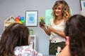 Female teacher showing pansy plant to her students in ecology classroom