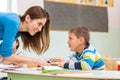 Female teacher shows the children the book, reading Royalty Free Stock Photo