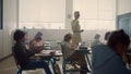 Female teacher and students with digital tablets having lesson in classroom Royalty Free Stock Photo