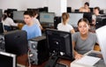 Female teacher uses a scanner in computer lab at school