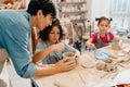 Female teacher working with group of kids in pottery workshop Royalty Free Stock Photo