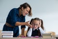 A female teacher yells at a student. Little girl covers her ears with her hands.