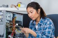 Female tech tests electronic equipment in service centre Royalty Free Stock Photo