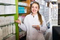 Female technician in chemist shop. Royalty Free Stock Photo