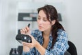 Female technician disassemble parts camera to fixed