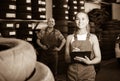 Female technician in overalls holding clipboard in car workshop Royalty Free Stock Photo