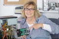 female technician pointing at repaired computer