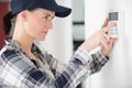 female technician programming electronic keypad