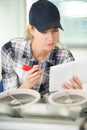 female technician reading instruction manual Royalty Free Stock Photo