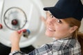 female technician repairing boiler Royalty Free Stock Photo
