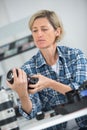 female technician repairing dslr lense