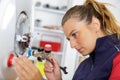 Female technician servicing boiler Royalty Free Stock Photo