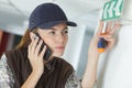 Female technician using smart phone emergency exit