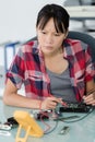 female technician using voltage meter on hard drive Royalty Free Stock Photo