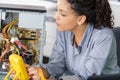 Female technician using voltage meter for measuring pc Royalty Free Stock Photo