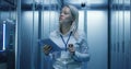 Female technician works on a tablet in a data center Royalty Free Stock Photo