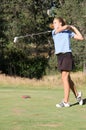 Female teen golfer after swing Royalty Free Stock Photo