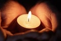 Female teen hands holding burning candle Royalty Free Stock Photo