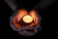 Female teen hands holding burning candle Royalty Free Stock Photo