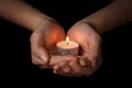 Female teen hands holding burning candle Royalty Free Stock Photo