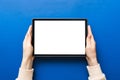 female teen hands using tablet pc with white screen, Mockup image of woman hand holding white tablet pc with blank white Royalty Free Stock Photo