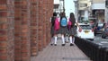 Female Teen Students Walking With Backpacks