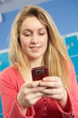 Female Teenage Student Using Mobile Phone Royalty Free Stock Photo