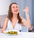 Female teenager is enjoying tasty green salad Royalty Free Stock Photo