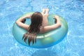 Female teenager floating on float in pool