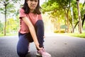 Female teenager hand touching painful twisted or ankle sprain,feel ache,ankle injury after exercise at park,asian child girl have